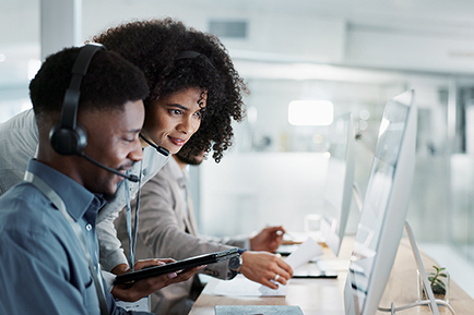 Two People at a Computer being trained